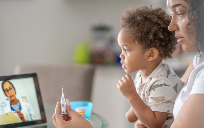 Mother On A Remote Medical Call With A Doctor About Her Sick Child