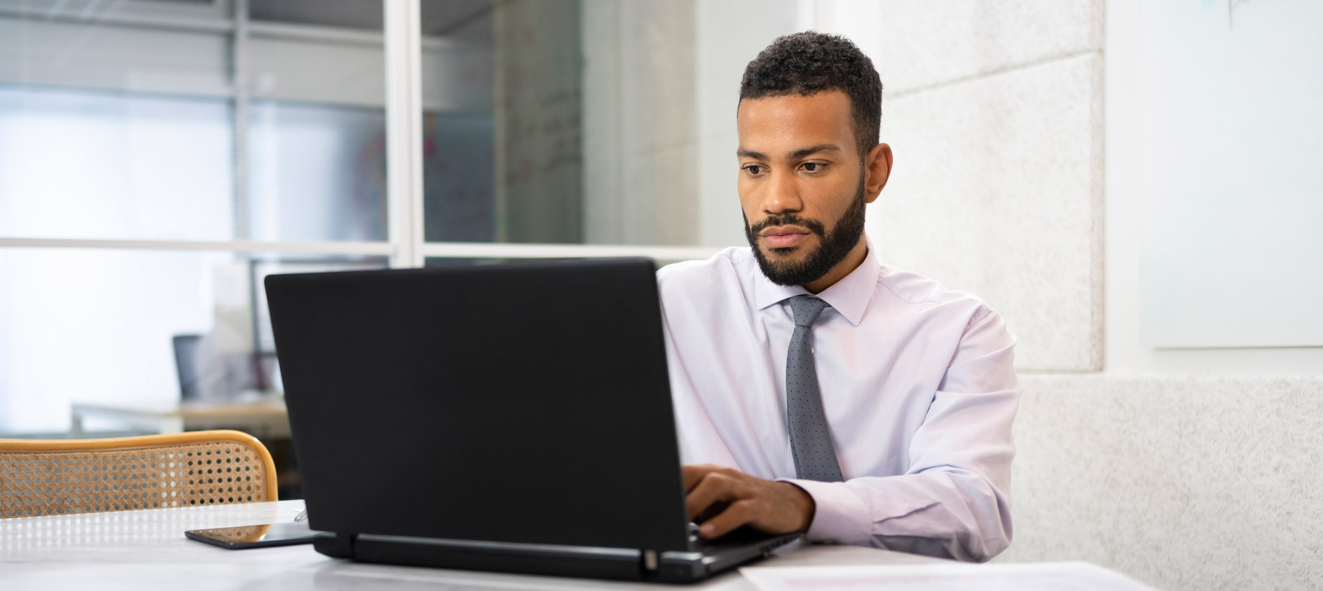 Businessman Working With Laptop While Sitting In Office