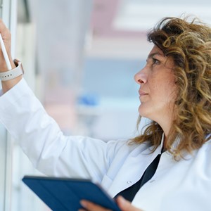 Pharmacist Using A Digital Tablet To Do Inventory In A Pharmacy