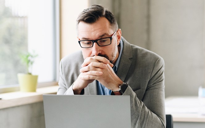 Businessman Working On Laptop Computer In Office