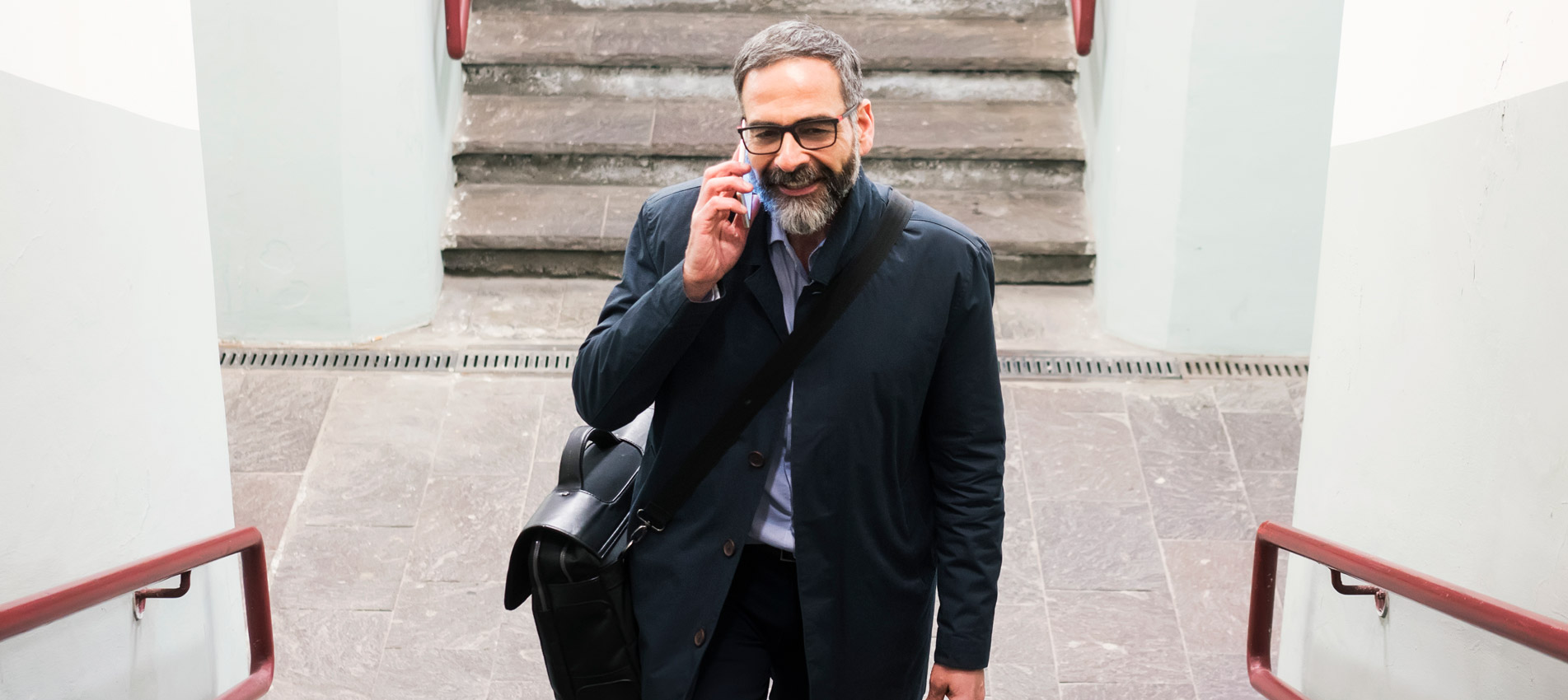 Mature Businessman At Train Station Walking Up The Stairs