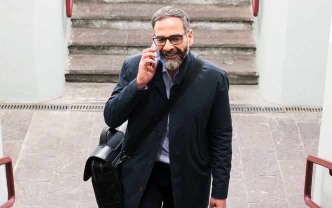 Mature Businessman At Train Station Walking Up The Stairs