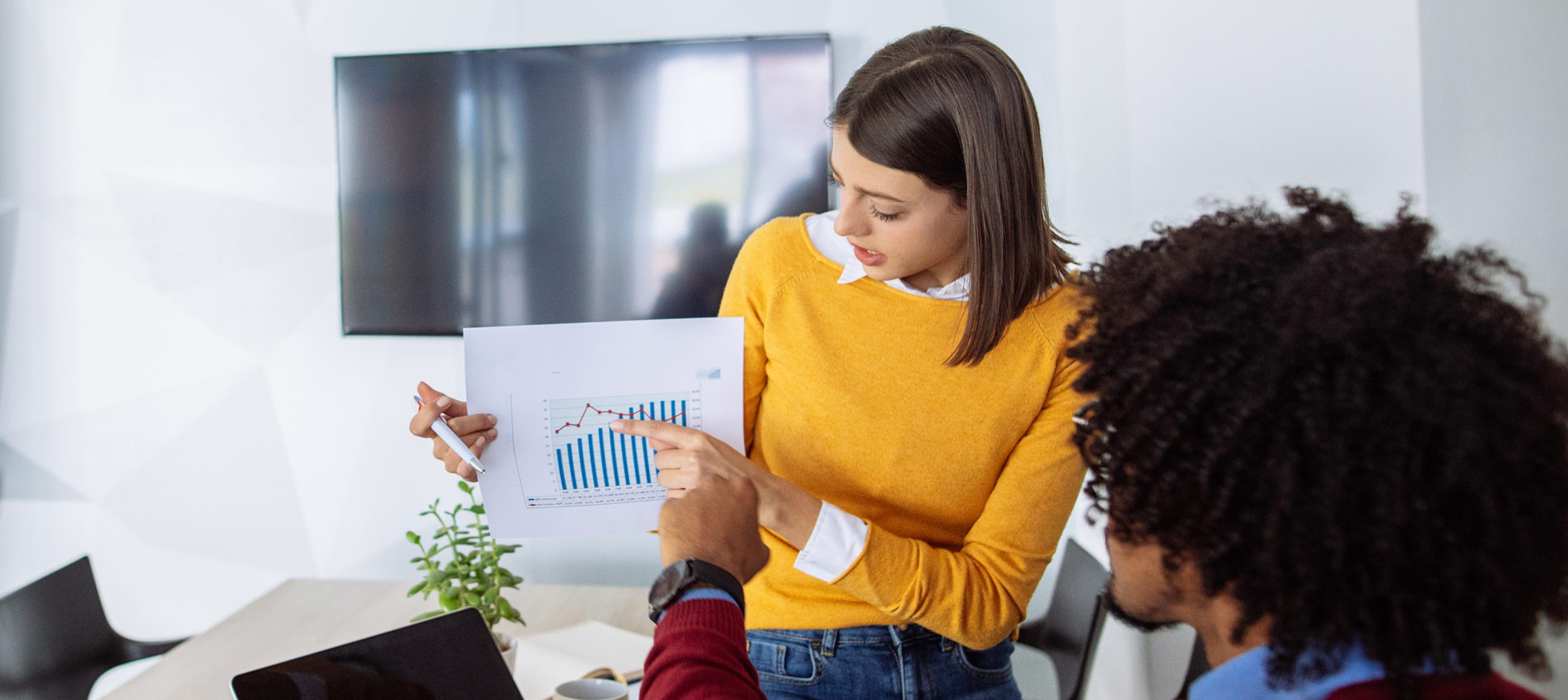 Young Businesswoman Sharing Business Reports With Colleagues