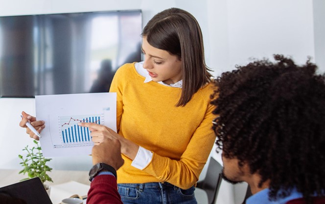 Young Businesswoman Sharing Business Reports With Colleagues