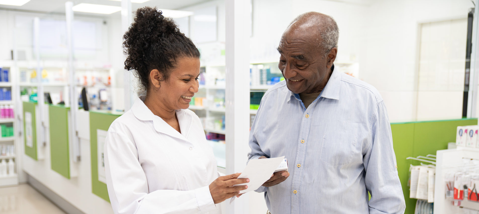 Pharmacist Helping Customer With Prescription Medicine
