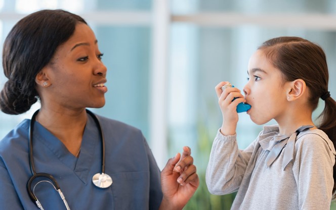 Female Doctor Assists Young Asthmatic Girl