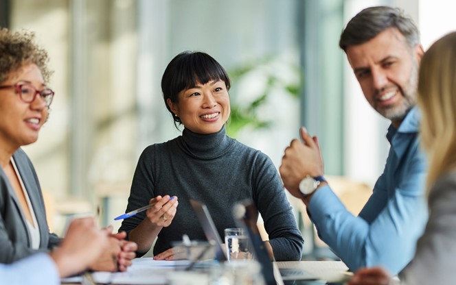 Happy Multiracial Business Team Talking On A Meeting In The Office
