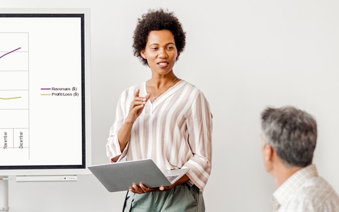 Black Businesswoman Gives A Presentation To Her Business Colleagues In The Conference Room