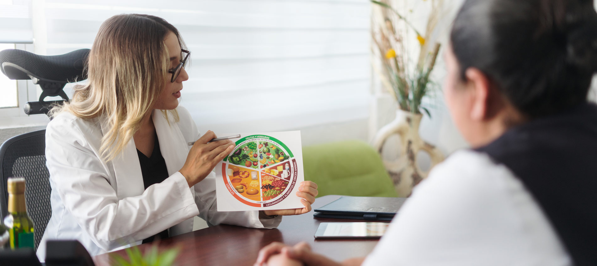 Female Nutritionist Holding Image Of Healthy Eating Plate