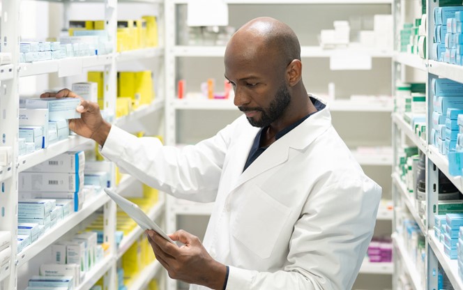 Pharmacist Taking Inventory With Digital Tablet