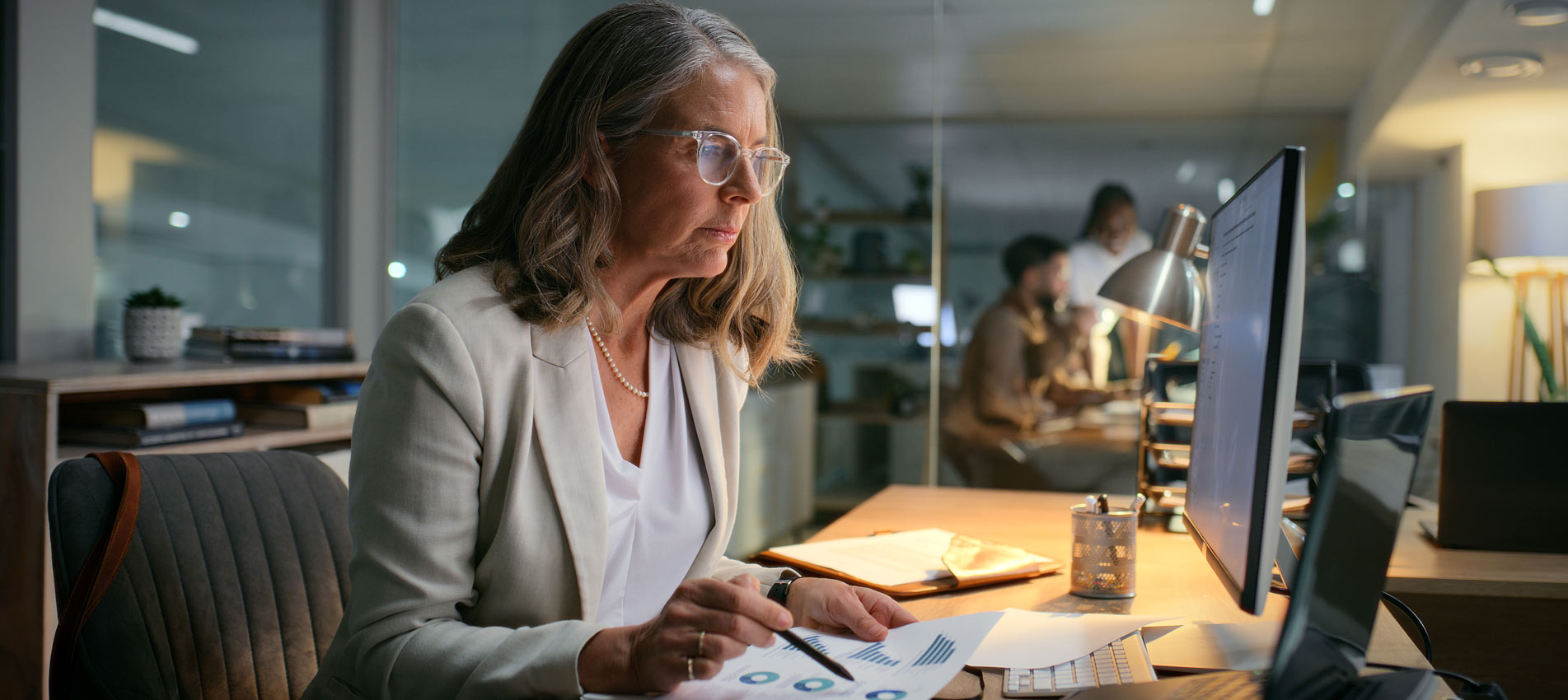 Businesswoman Reviewing Finance Charts In The Office