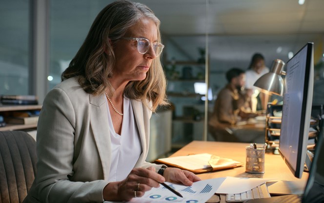Businesswoman Reviewing Finance Charts In The Office
