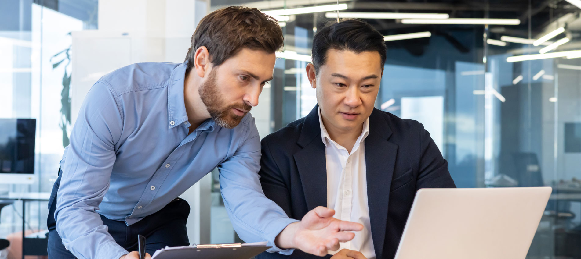 Two Business People At A Meeting Discussing Cybersecurity