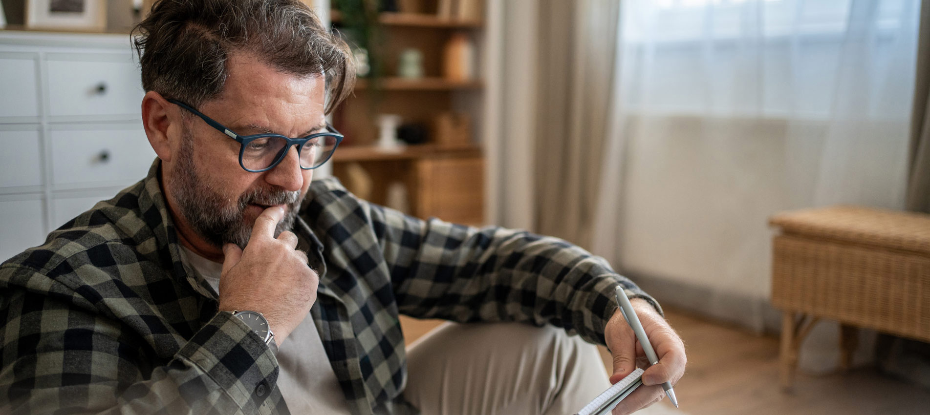 Worried Mature Man Calculating Domestic Bills At Home