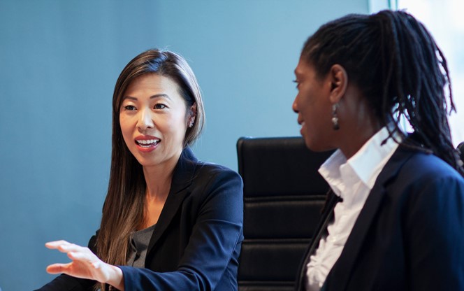 Asian Mid Adult Woman Businesswoman Discussing Ideas During Business Meeting