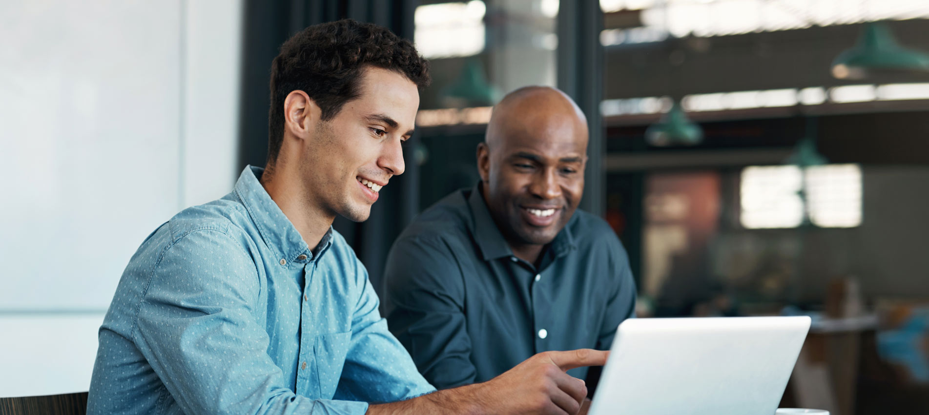 Colleague Branding Ideas With A Creative Designer On A Laptop In An Office