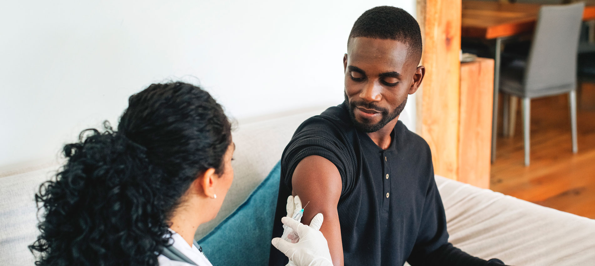 Doctor Vaccinating A Young Man