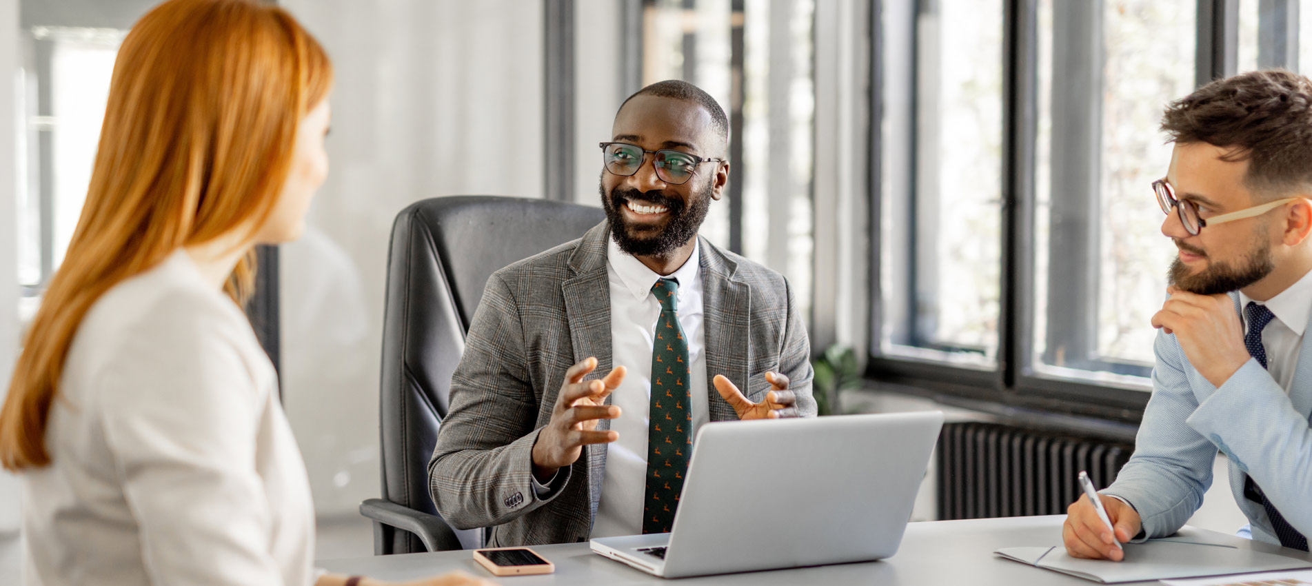 African American Male Consultant Having A Discussion With Clients