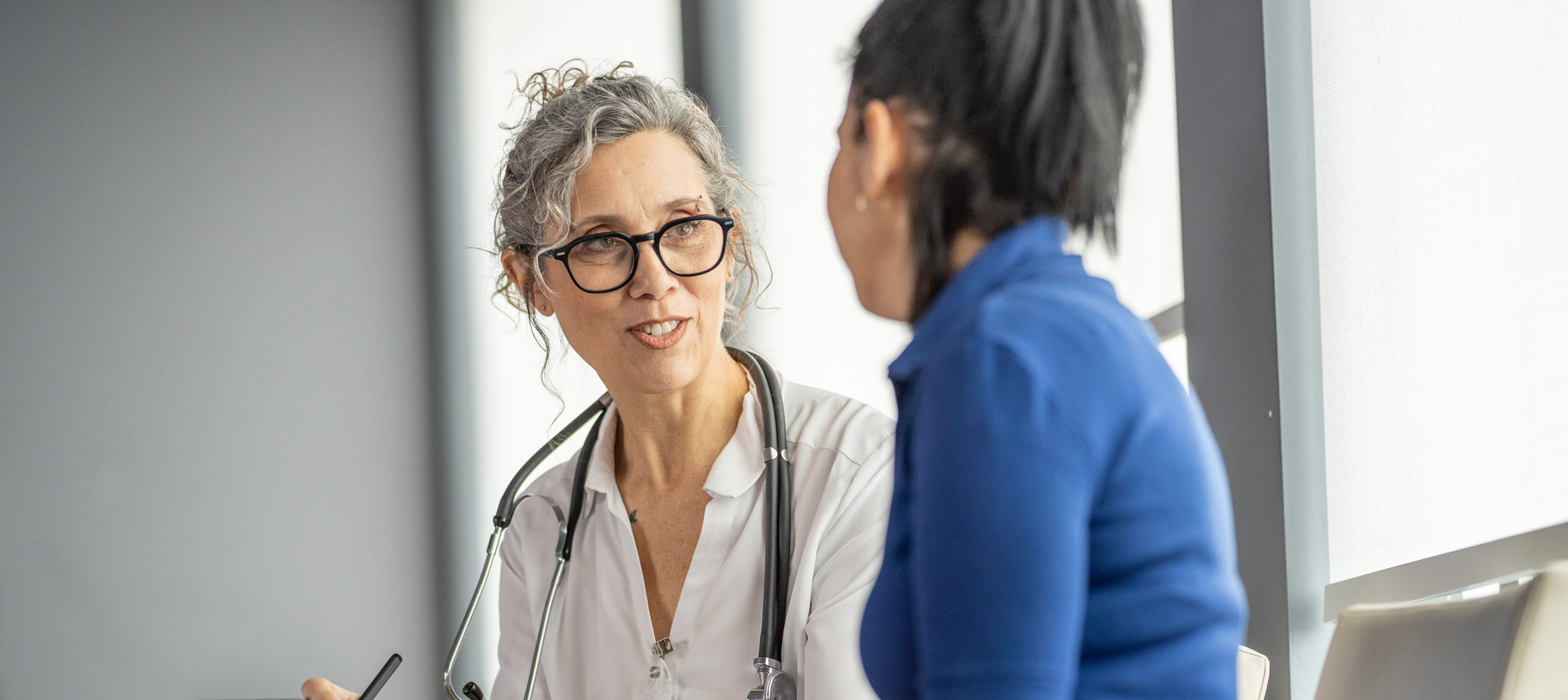 Doctor Consulting With Patient During A Medical Appointment In Clinic