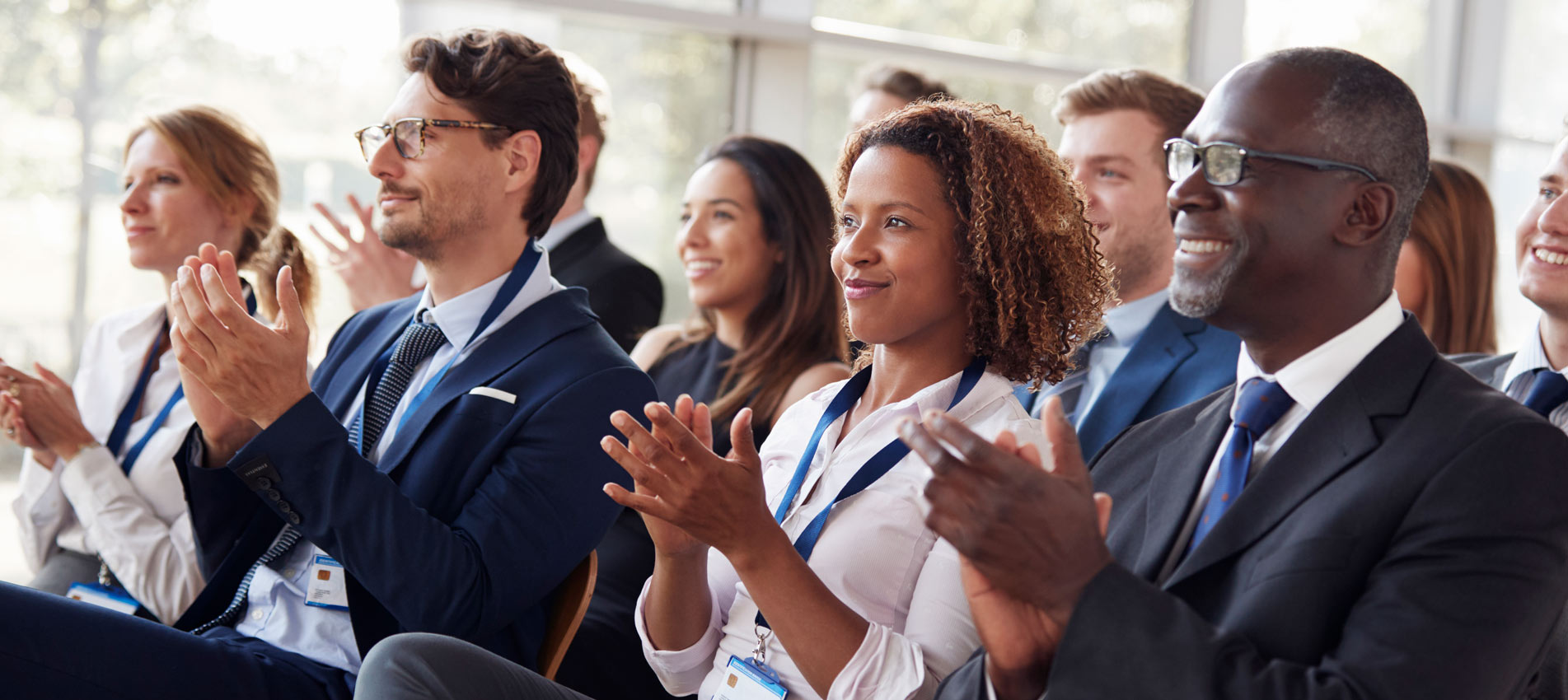 Smiling Audience Applauding At A Company Meeting