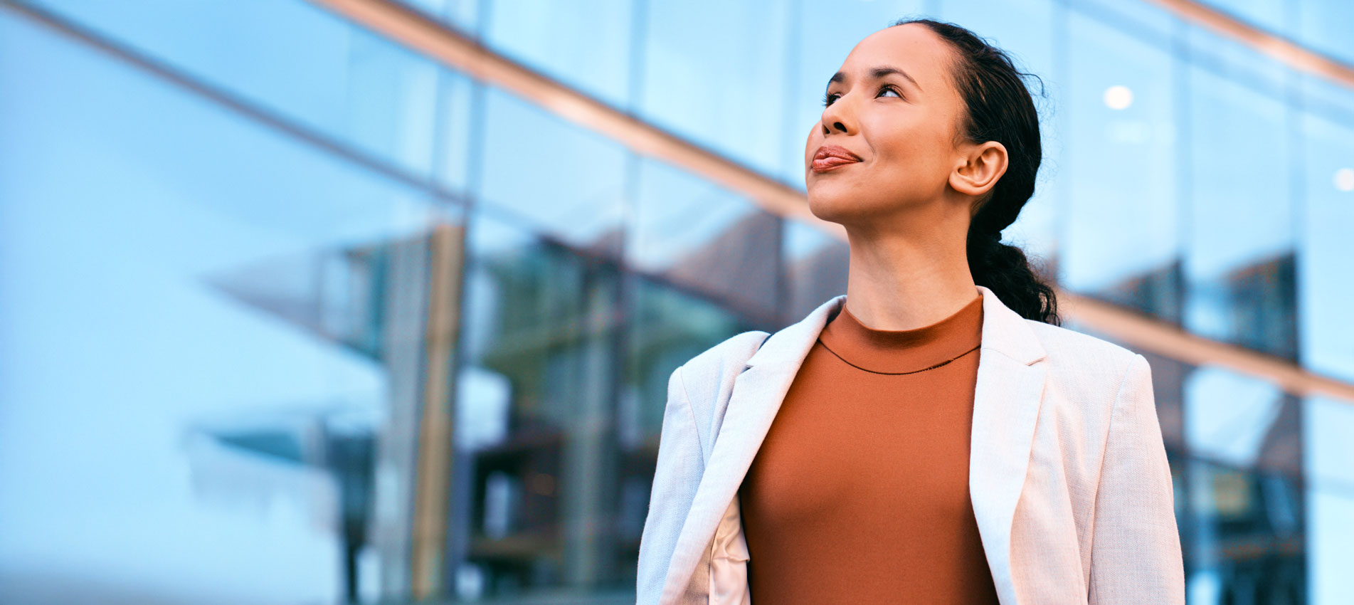 Confident Businesswoman Standing Looking Onwoard In Front Of A Building