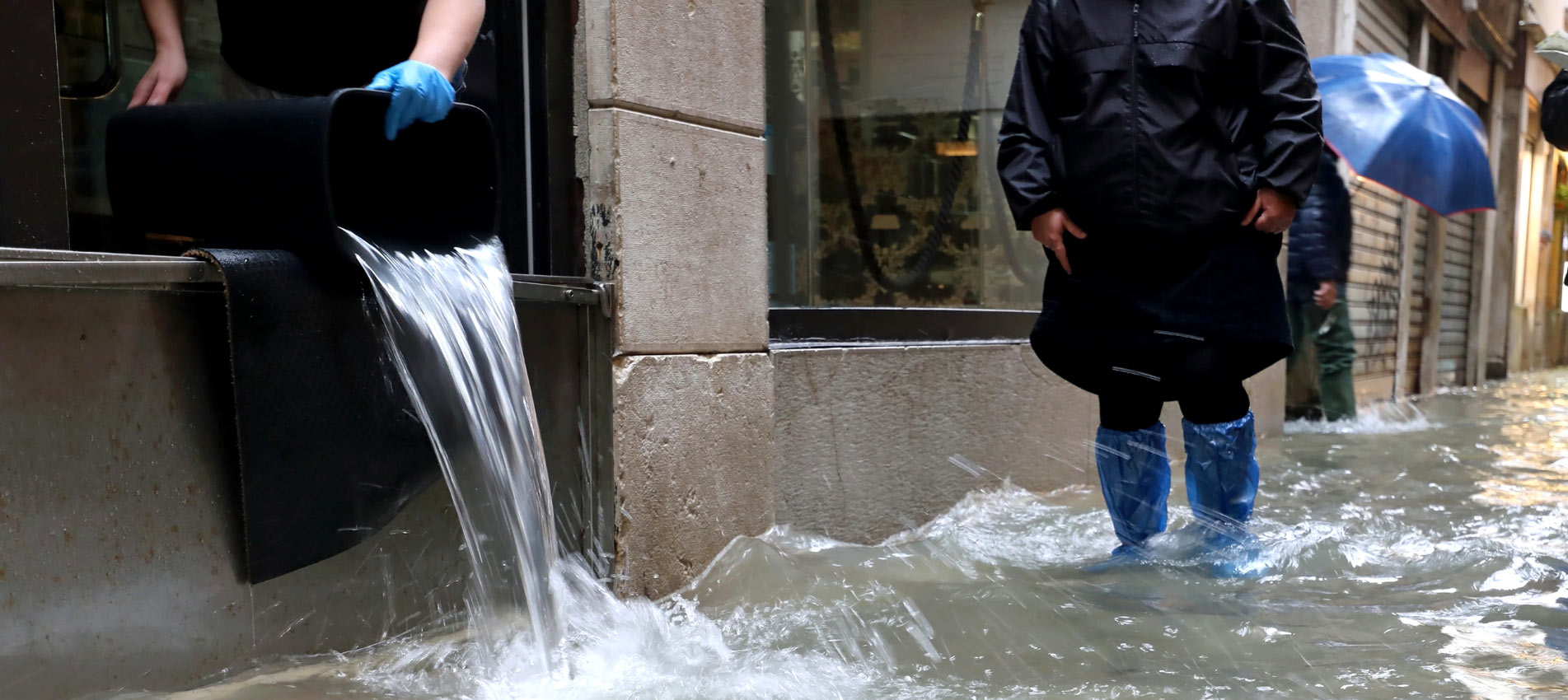 Person Emptying Flood Water From A Building
