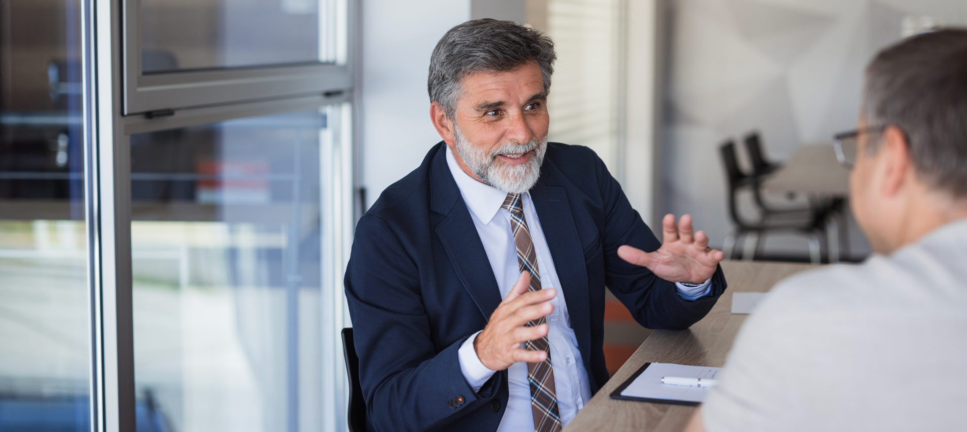 Two Businessmen Are Discussing During A Meeting In A Modern Office
