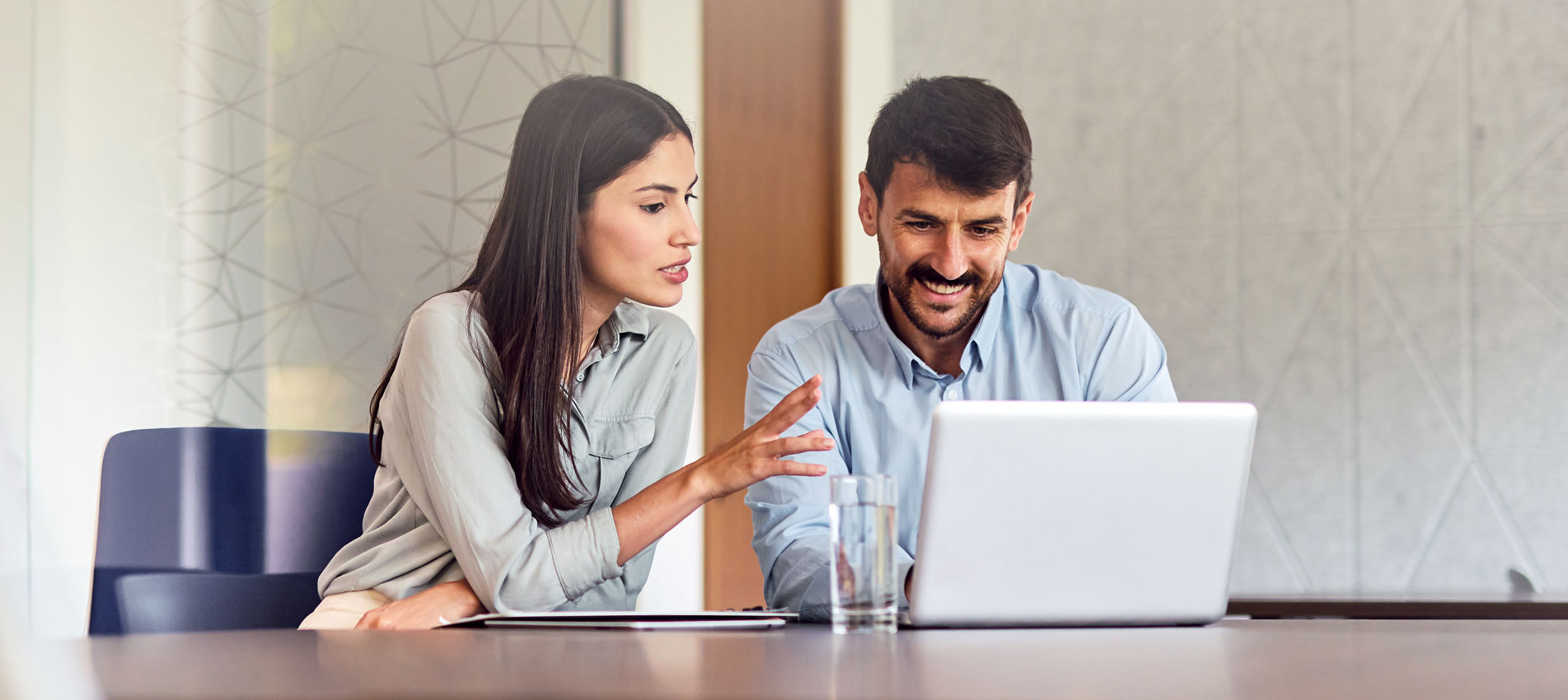 Two Businesspeople Working Together On A Laptop In The Office