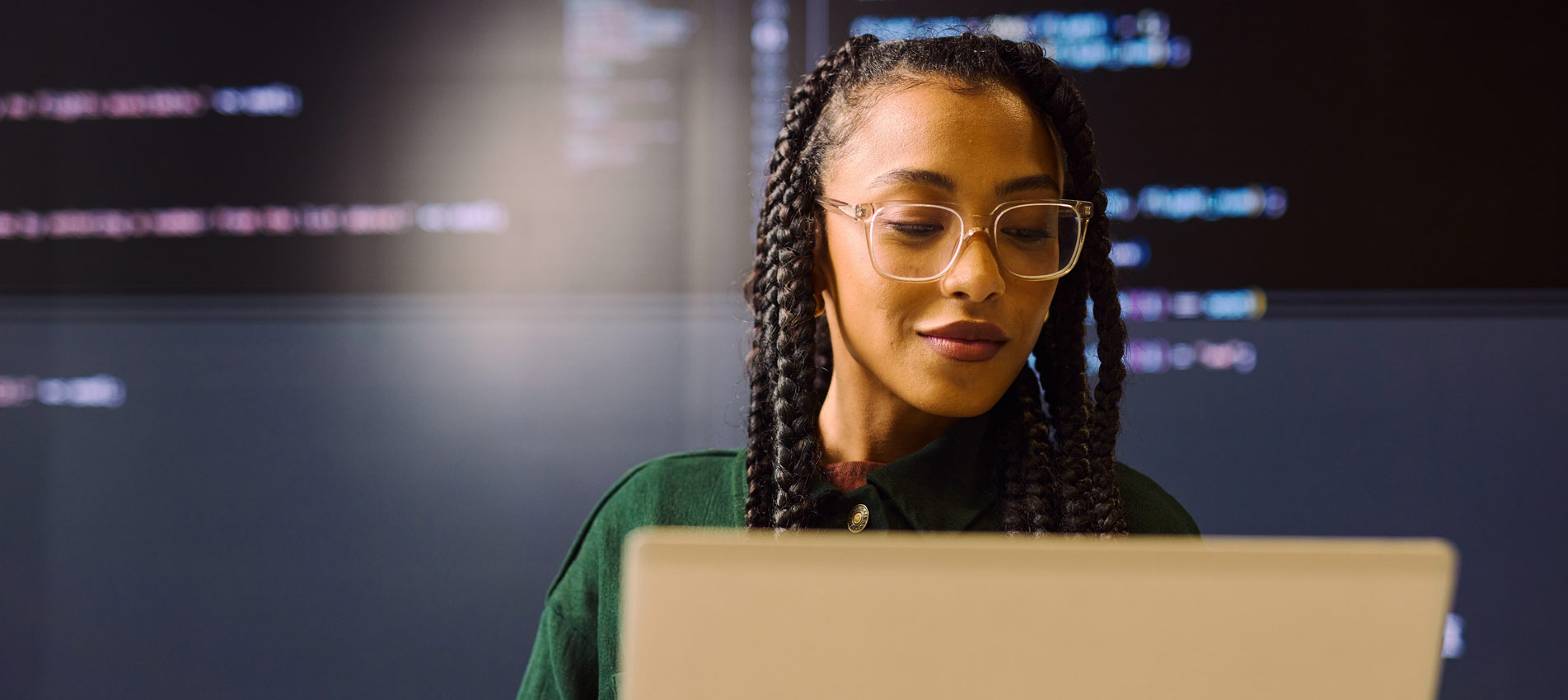 Young Businesswoman Analyzing Data On Laptop In Modern Office
