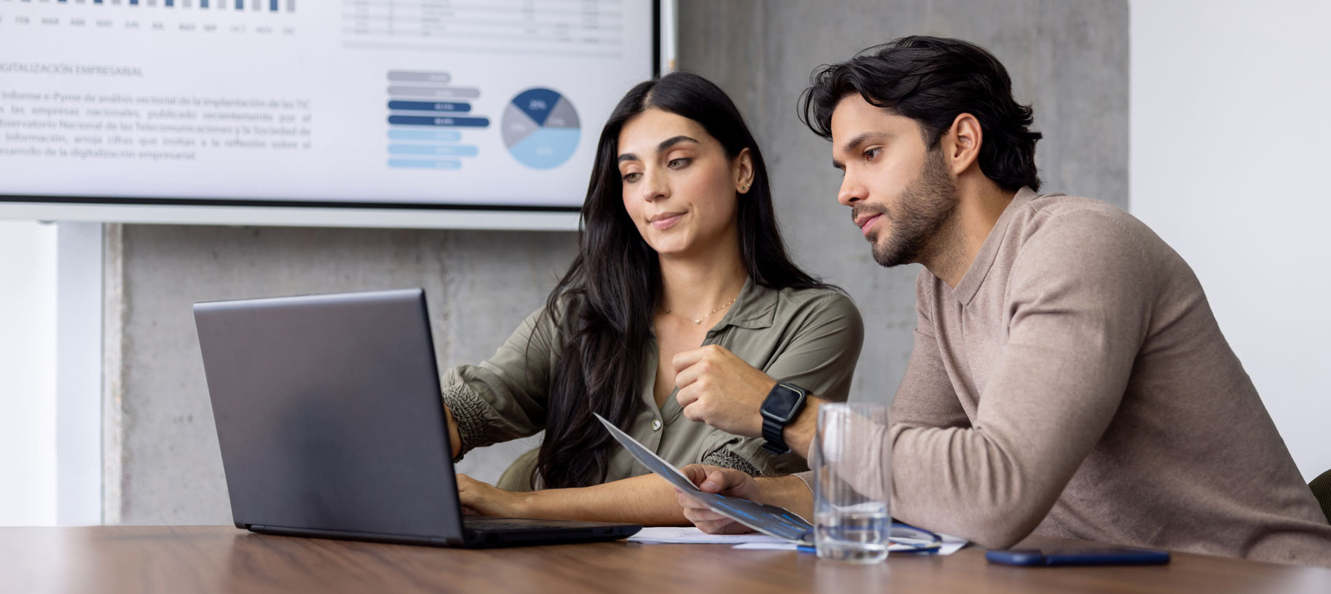 Business Colleagues Working Together At The Office Using A Laptop Computer