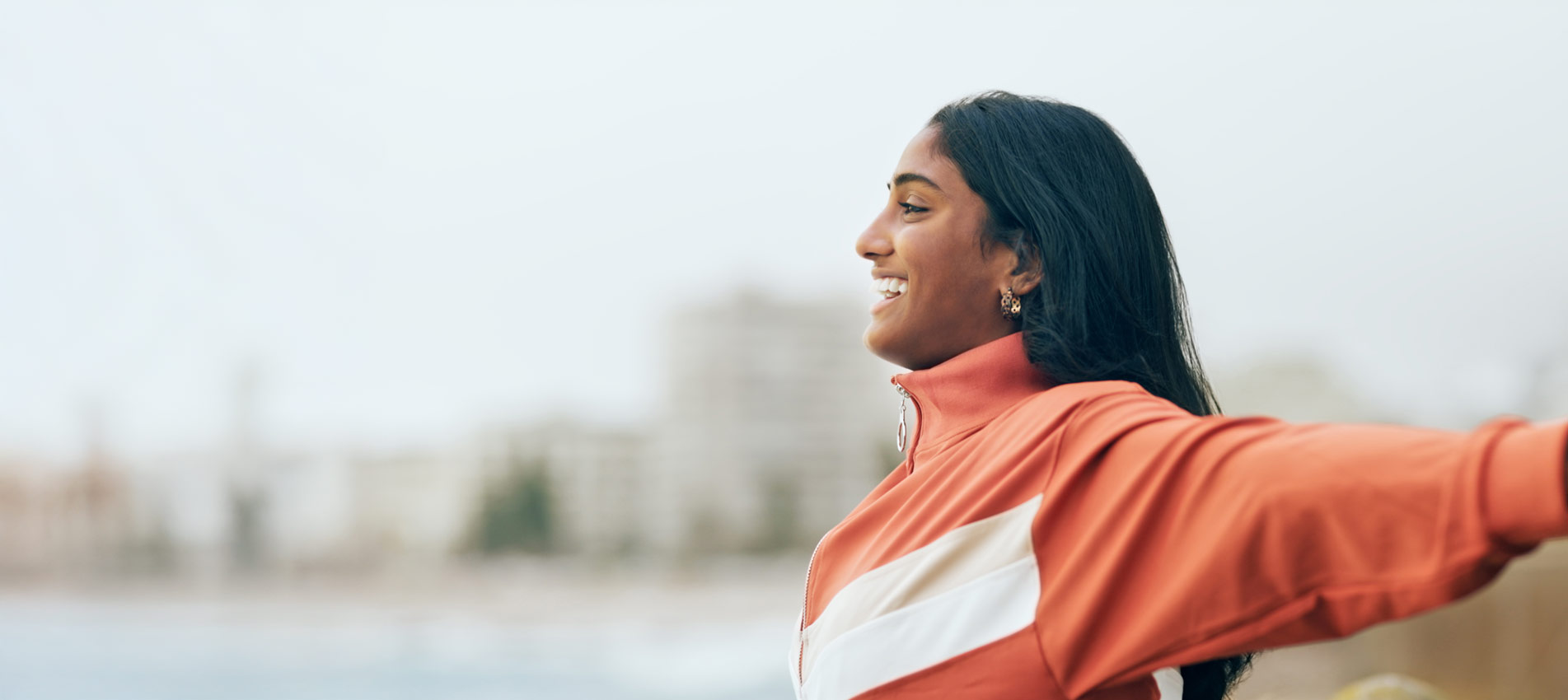 Happy Indian Woman Outdoor Freedom And Arms Out