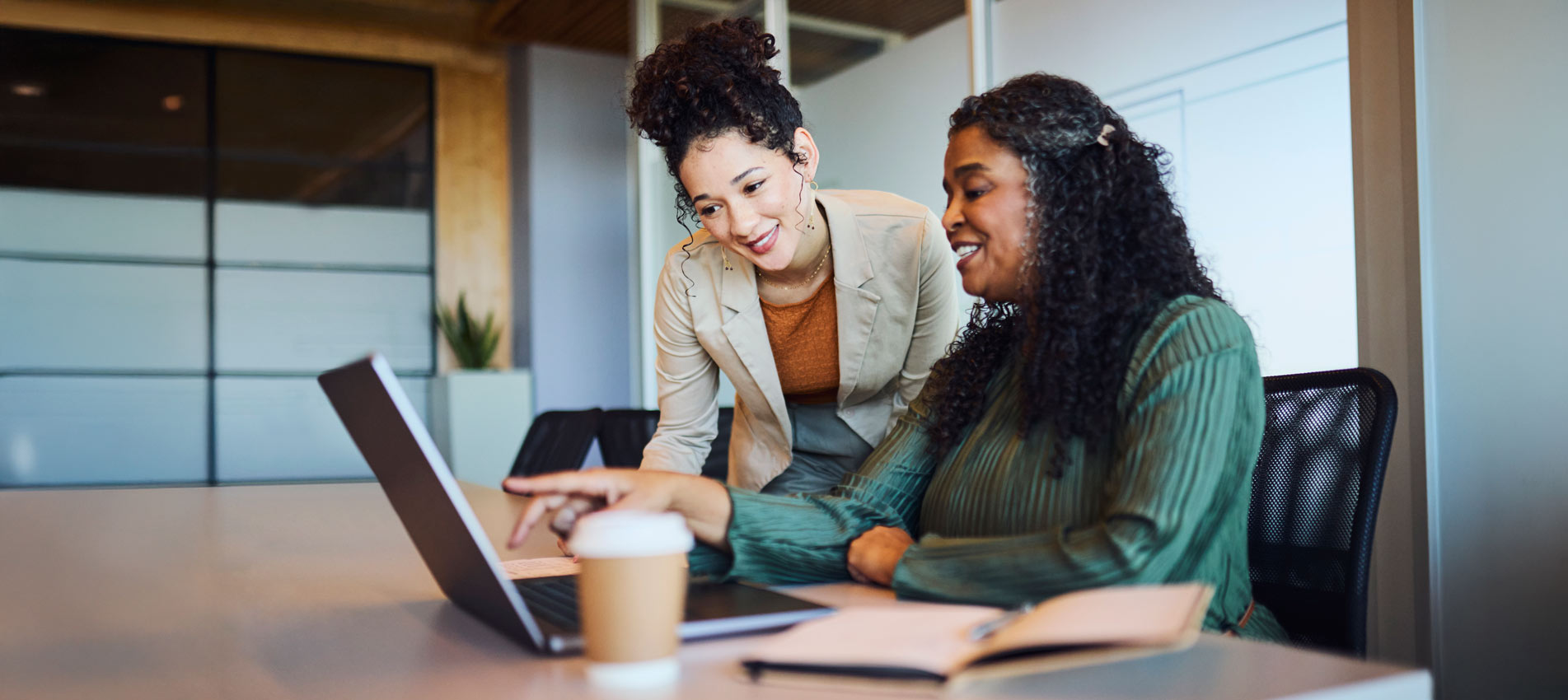 Diverse Businesswomen Collaborating On Laptop