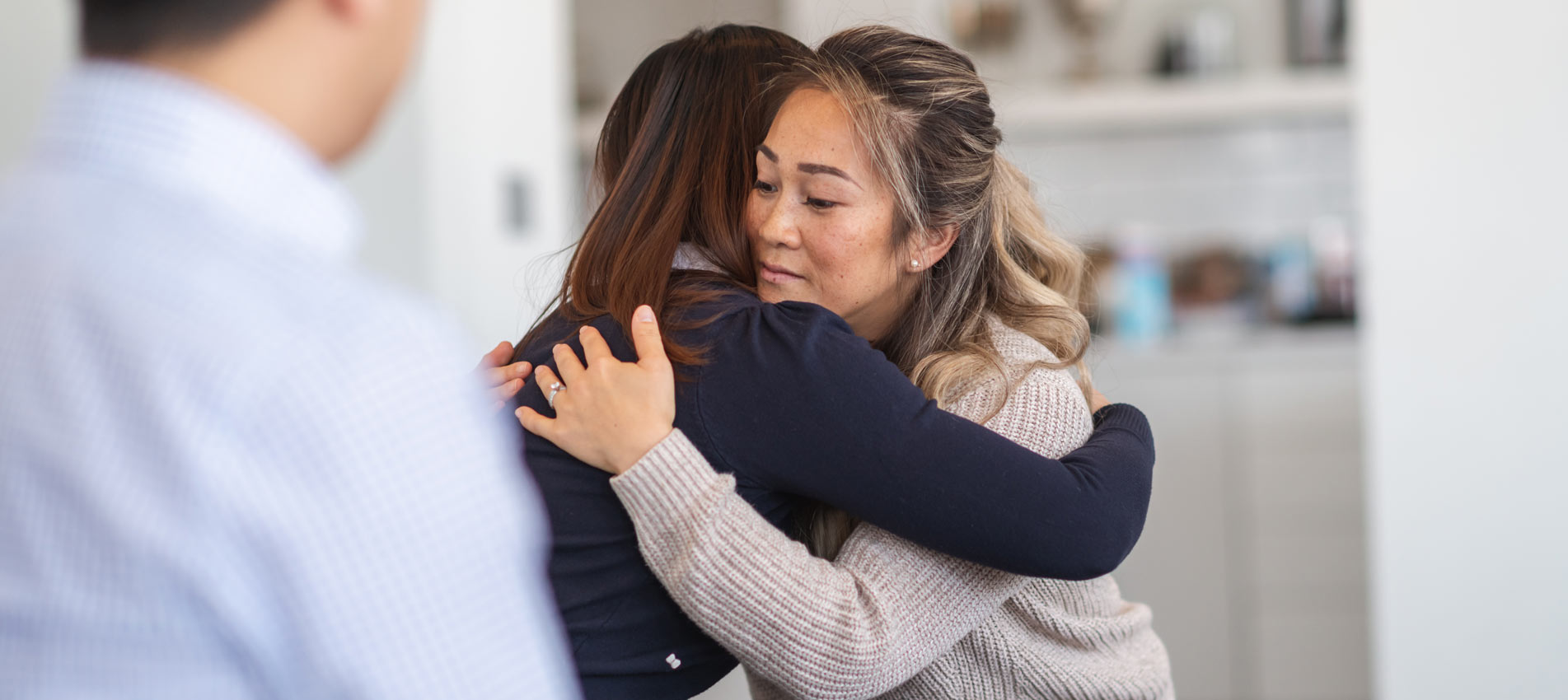 Two Women Hug In Therapy Session