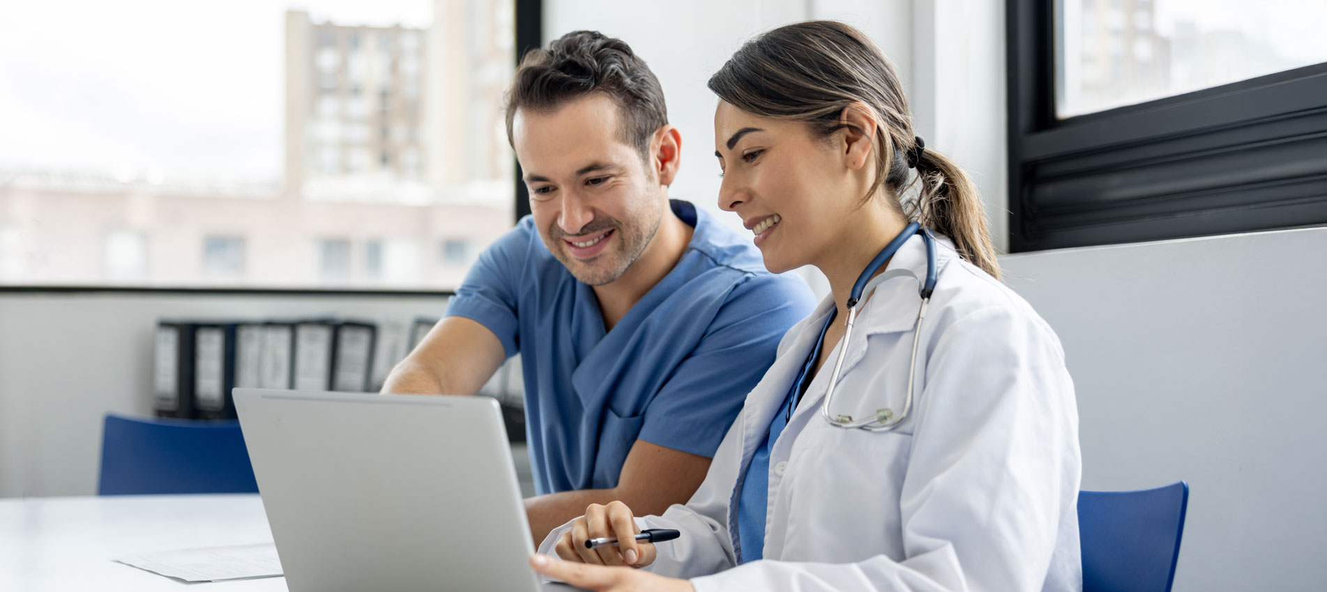 Team Of Doctors Using AI Program On A Laptop