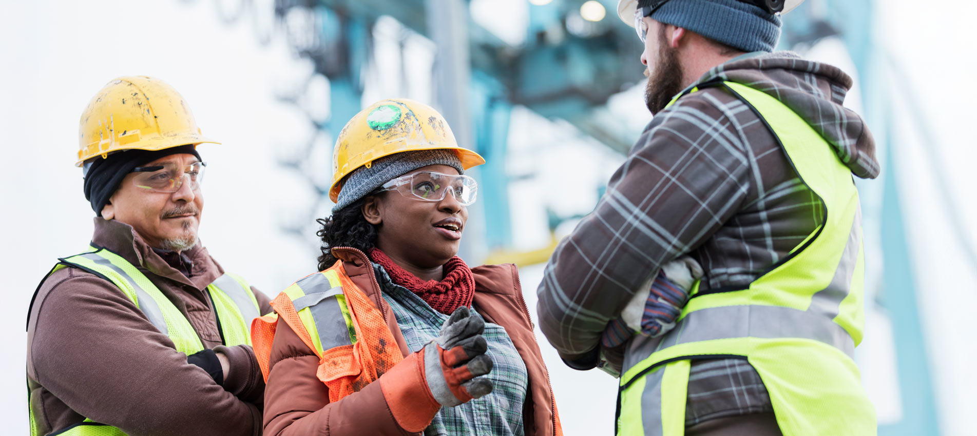 Three Multi Ethnic Construction Workers Having A Discussion