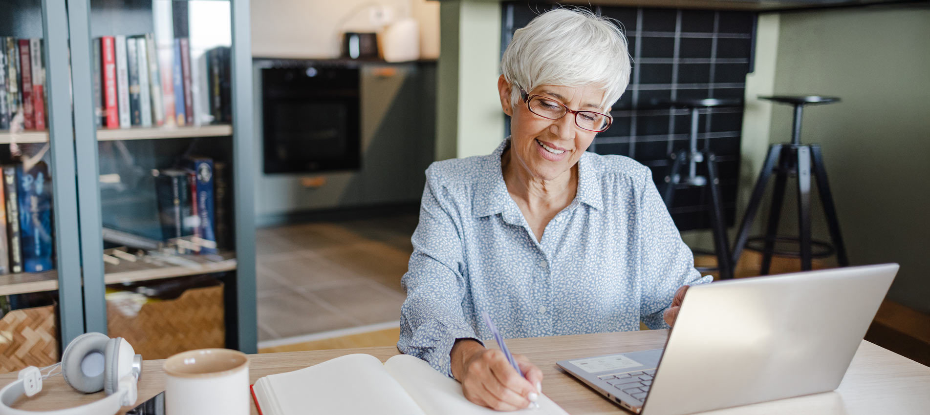 Senior Woman Uses A Laptop At Home