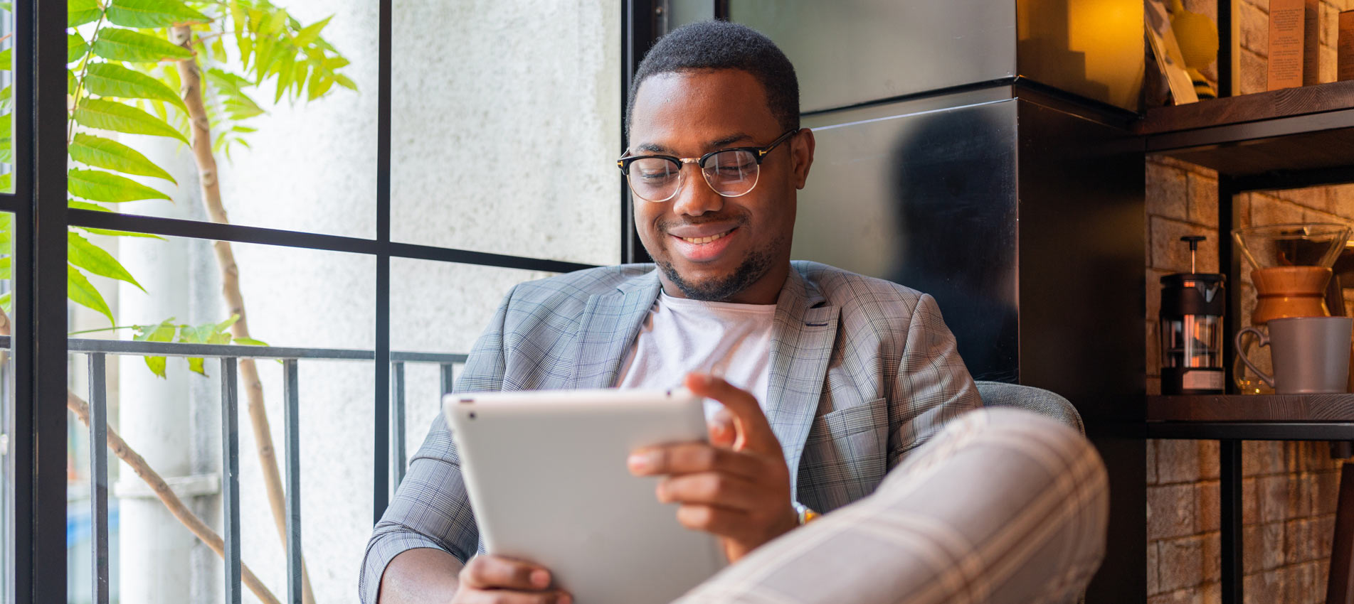 African Young Man Working On Digital Tablet At Coffee Shop