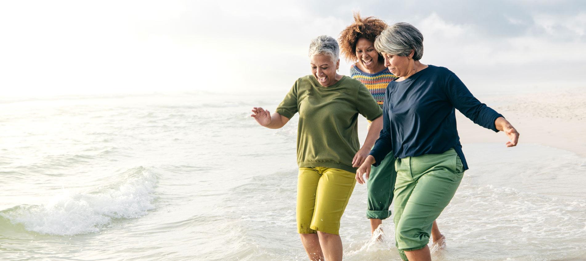 Joyful Senior Women Cherishing Friendship By The Beach On A Sunny Day