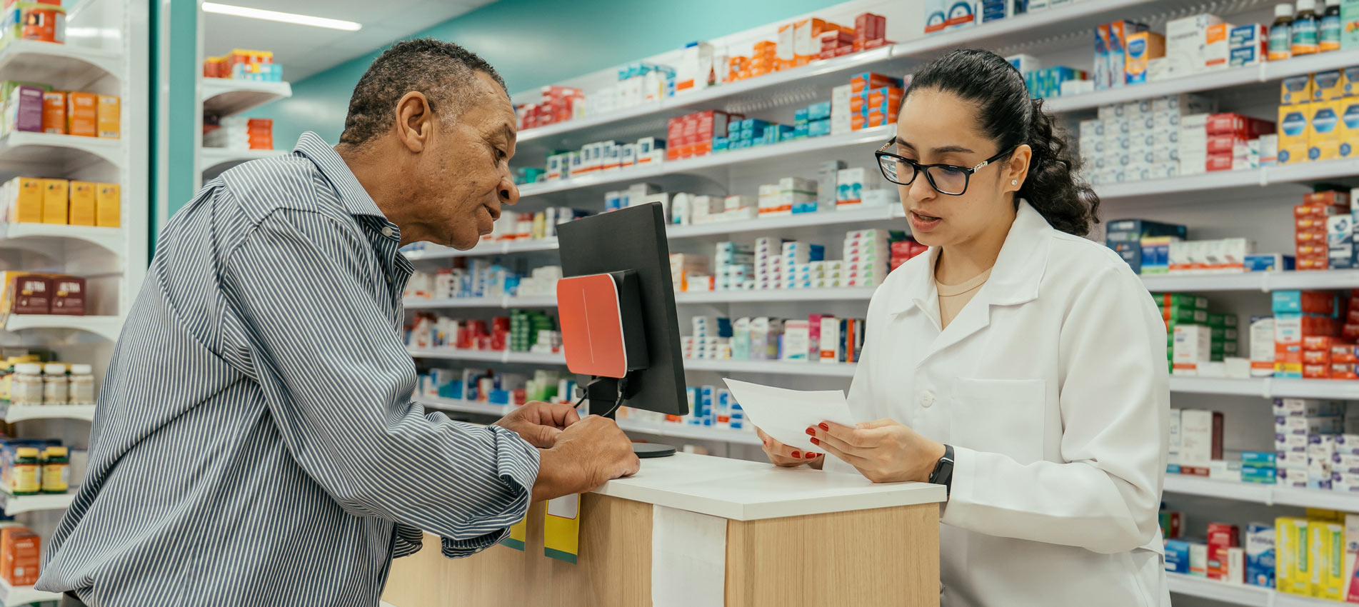 Female Pharmacist Explaining A Medication And Prescribing Medication To A Customer In The Pharmacy