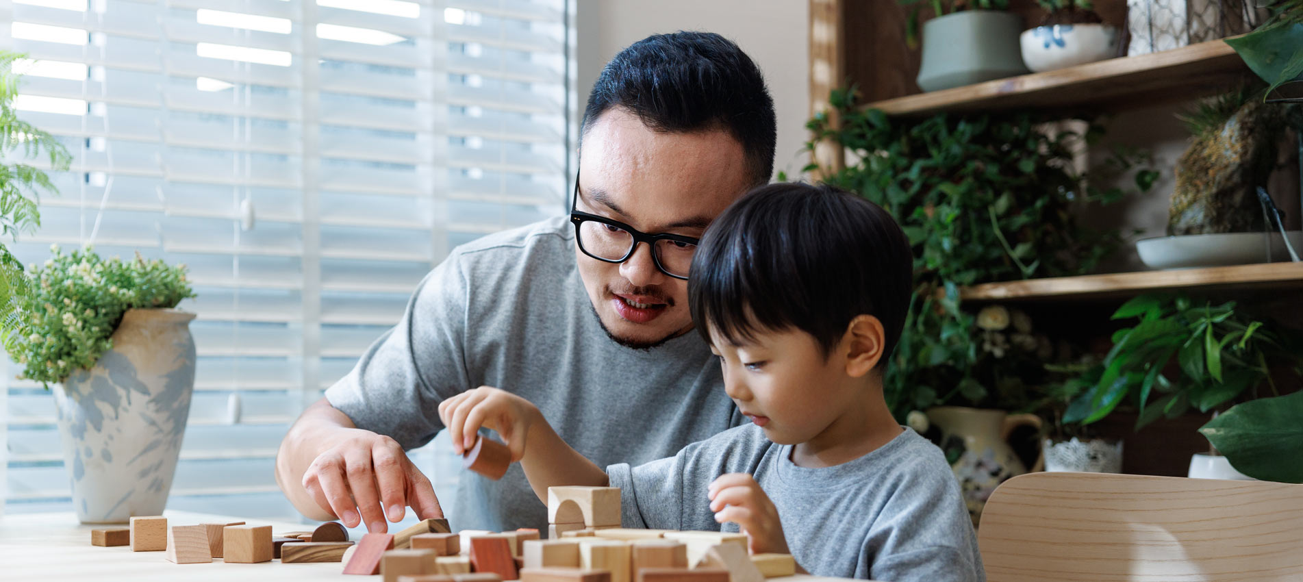 Asian Father And Son Playing With Building Blocks At Home