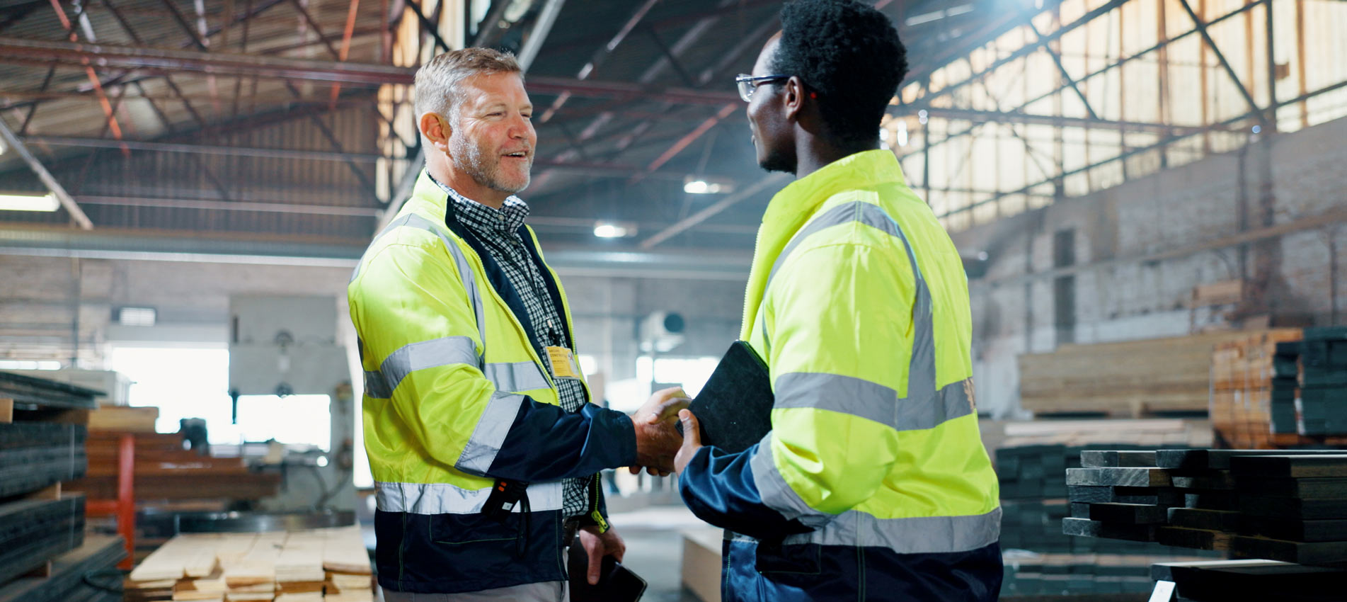 Enginee And Businessman In Agreement Handshake At Carpentary Workshop