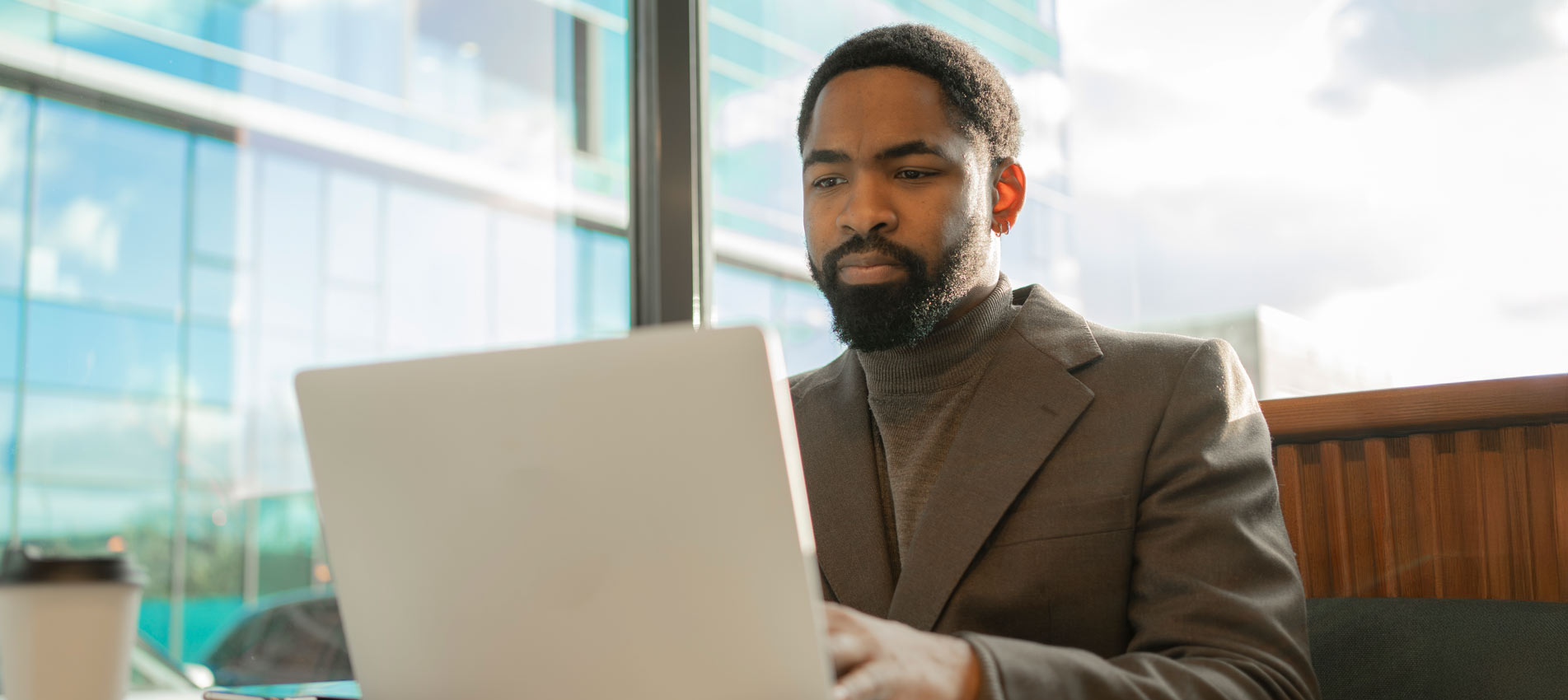 Business Black Man Working On Laptop In Modern Office