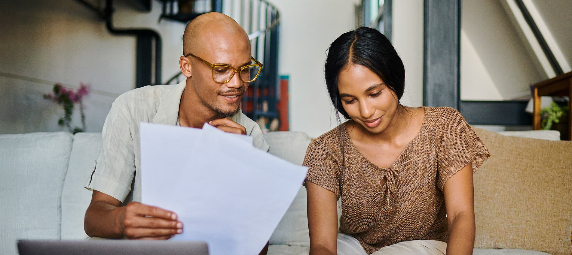 Young Couple Going Over Financial Documents At Home